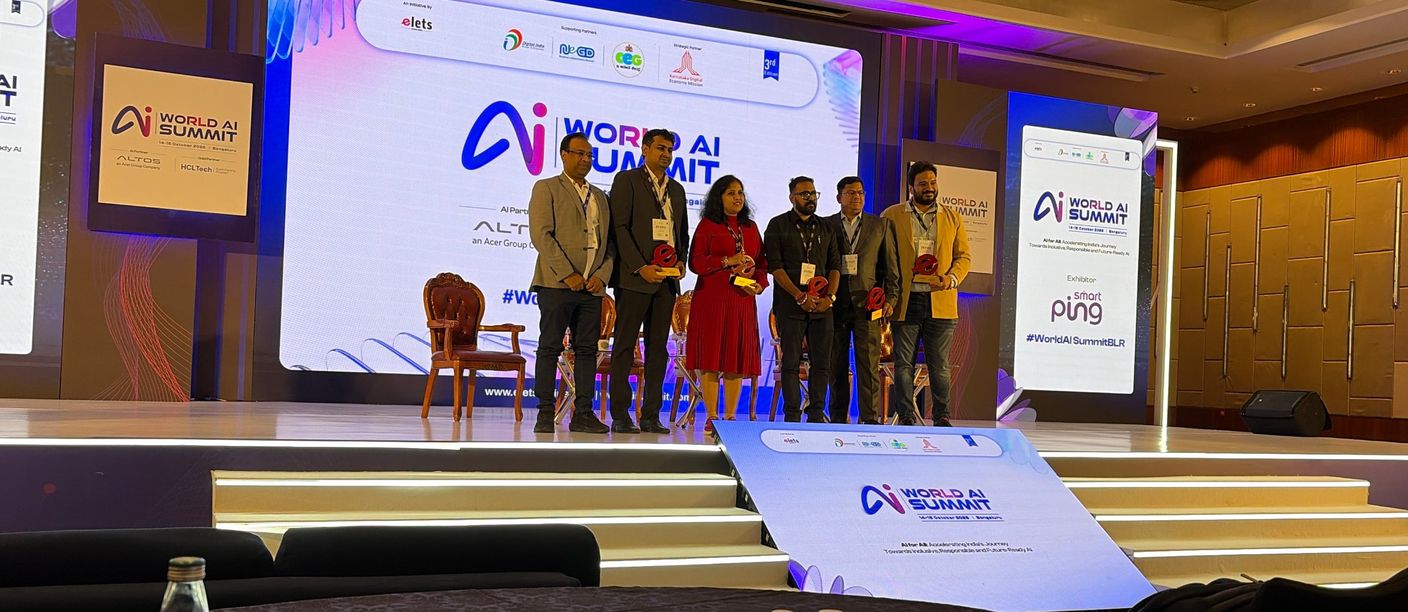 Panellists recognised on the main stage at World AI Summit 2026 Bengaluru with Smartping exhibitor branding
